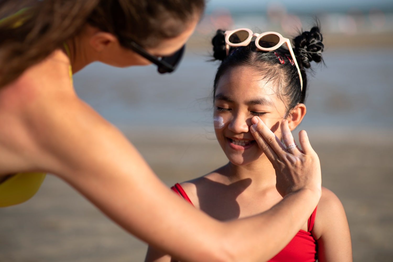 Applying SPF 30 sunscreen for summer sun protection—health and beauty tips for sunny days.