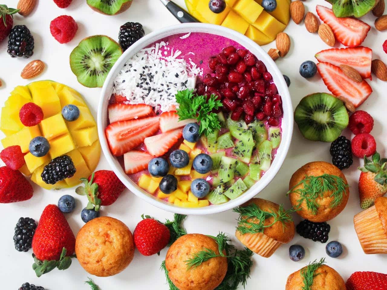 A colorful plate of fruits and nuts