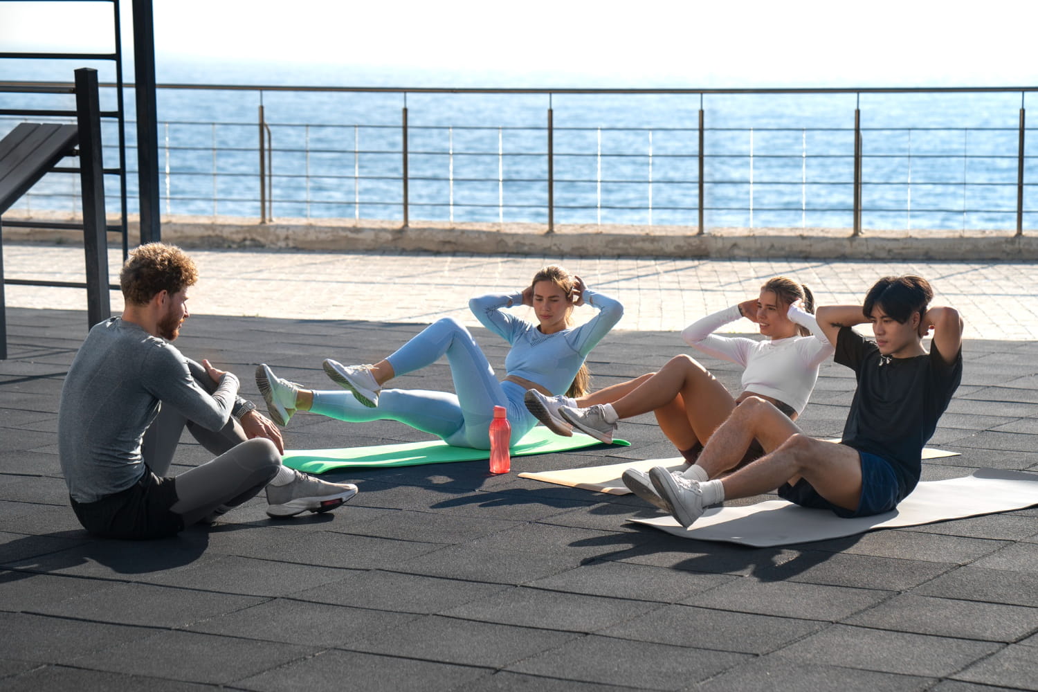 A happy fitness group exercising together for motivation and consistency.