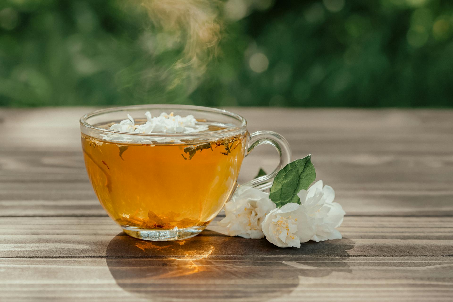 A cup of freshly brewed green tea with steam rising, depicting its calming effect.