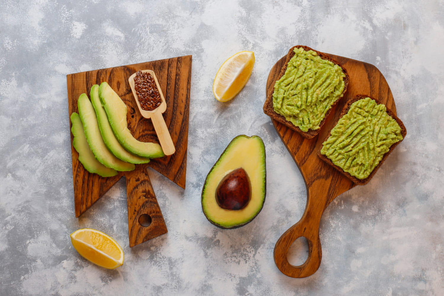 Avocado slices on a wooden board, showcasing its creamy superfoods for the skin texture.