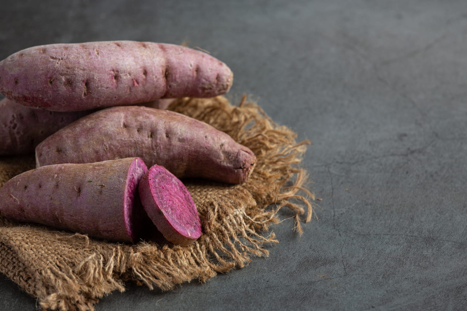 Sliced sweet potatoes on a plate, highlighting their orange color.