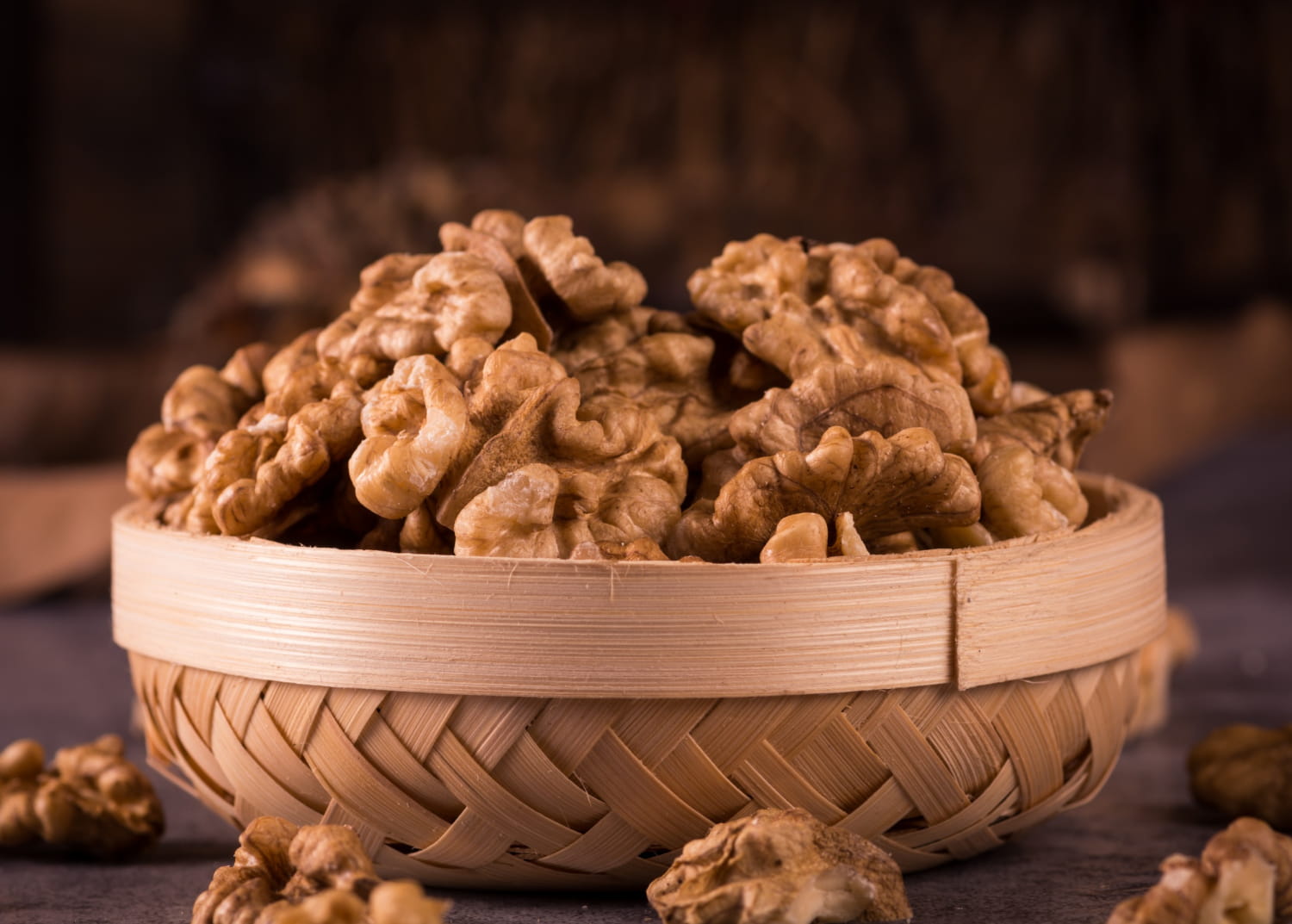 Walnuts in a wooden bowl, showing their crunchy superfoods for the skin texture.