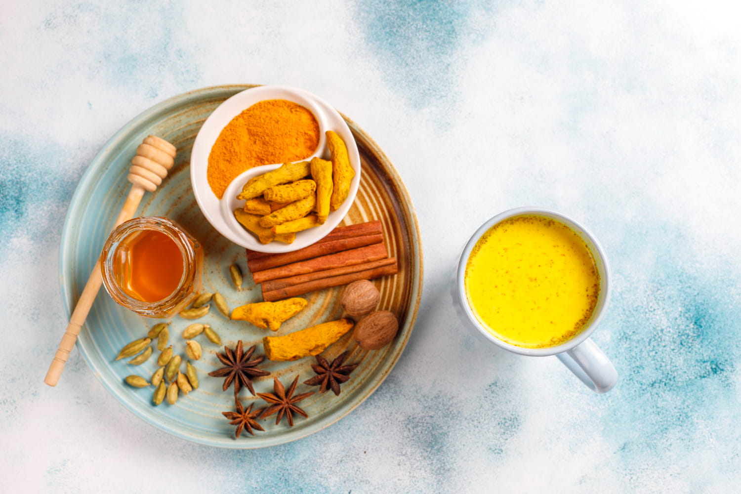 A bowl of homemade turmeric and honey skin detox mask.